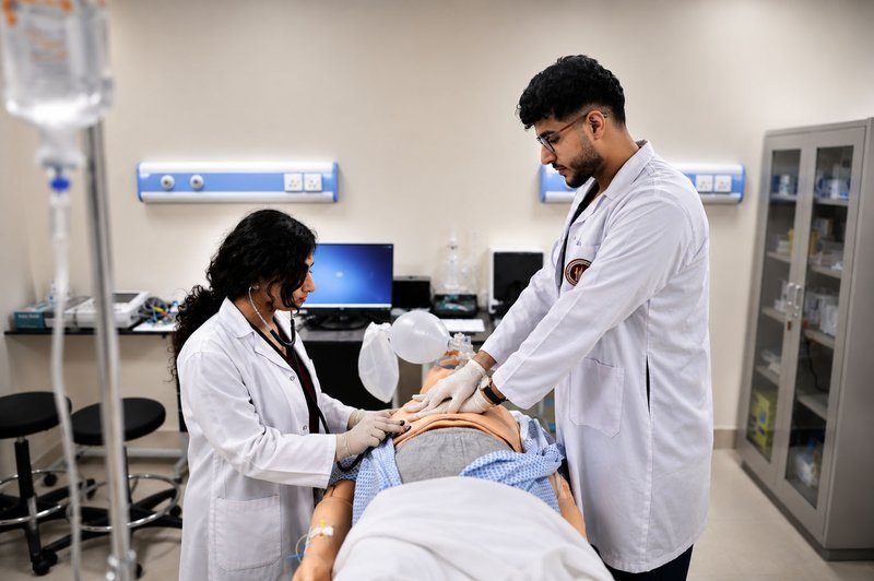 Two RAKMHSU medical students practising resuscitation on a patient simulator in the clinical simulation laboratory