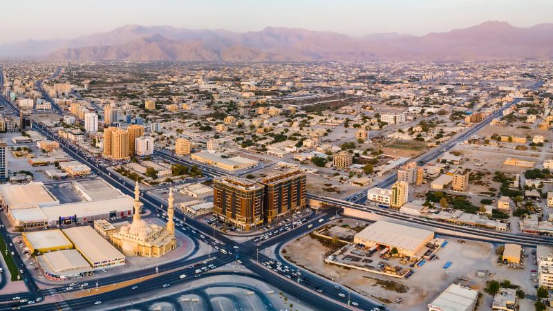 Aerial view of the Ras Al Khaimah cityscape backed by mountains