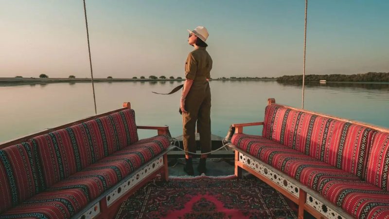 Traditional dhow on calm waters in Ras Al Khaimah at sunset
